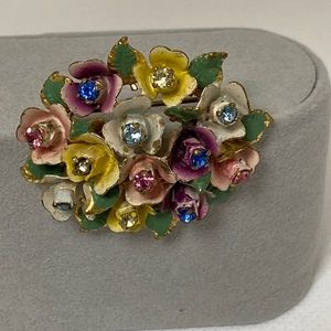 Marked “MADE IN AUSTRIA” metal floral brooch w crystal centers in 12 flowers.